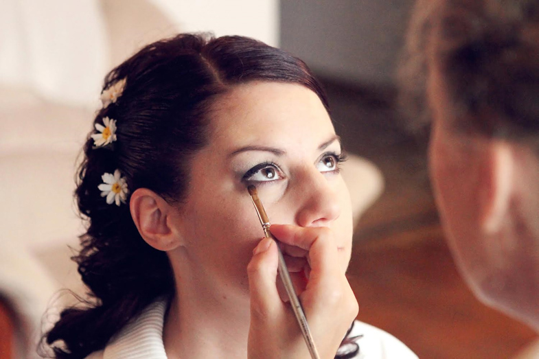 Makeup artist Urška Grošelj during the makeup of the bride.